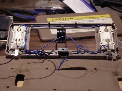 1994 Ford F-150 - Sun visor disassembled, showing internal wiring and light components, with a caution label visible.
