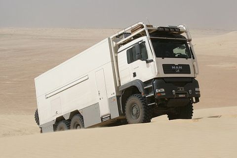 1993 Ford Bronco - MAN expedition truck navigates sandy terrain, its off-road capabilities.