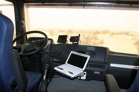1993 Ford Bronco - Dashboard of a truck with a laptop and navigation devices, overlooking a desert landscape.
