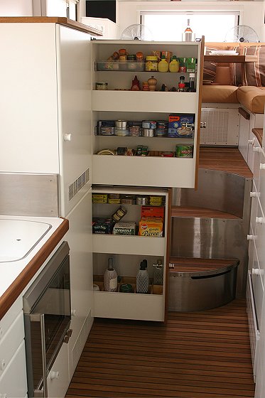 1993 Ford Bronco - The interior of a boat shows a well-stocked pantry and a view of the living quarters.