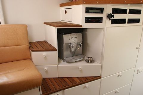 1993 Ford Bronco - This vehicle interior features a built-in espresso machine, cabinetry, and seating, suggesting a recreational vehicle or custom build.