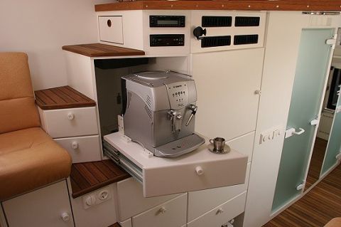 1993 Ford Bronco - The interior of an RV features a built-in espresso machine and cabinetry.