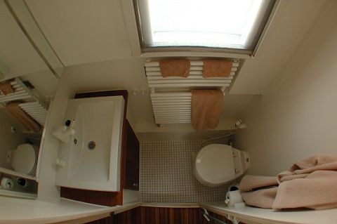 1993 Ford Bronco - This RV bathroom features a toilet, shower, and a towel rack with towels.