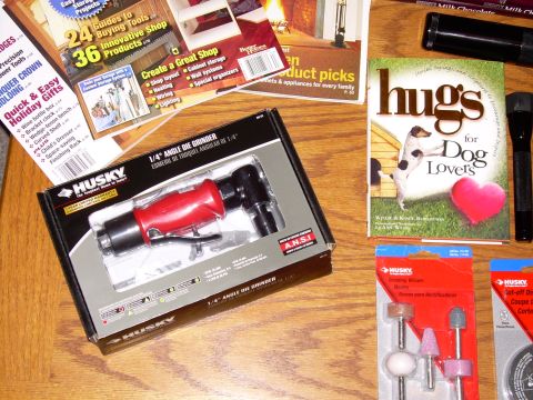 1966 Land Rover Discovery - A packaged Husky angle die grinder and assorted grinding wheels are displayed on a wooden surface.