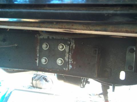1991 Ford Bronco - A close-up view of a vehicle's frame shows a metal plate bolted on for repair, with some writing visible.