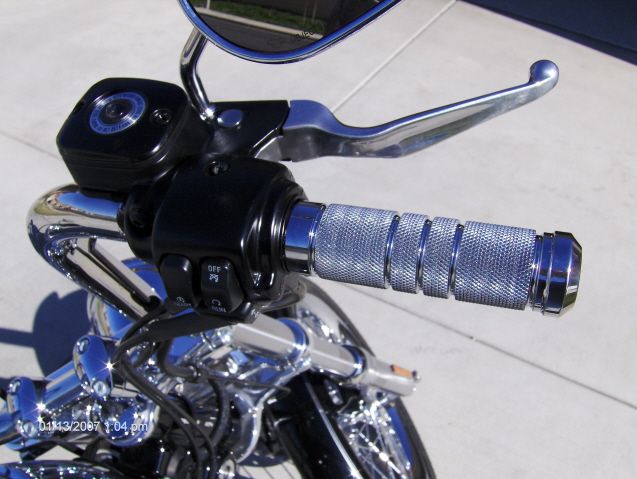 Motorcycle handlebar with chrome grips and brake lever. Date stamp 01/13/2007