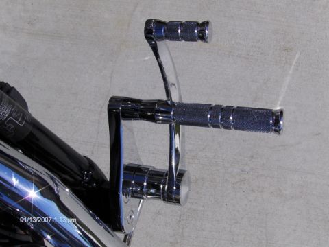 2004 Ford Crown Victoria - Close-up of motorcycle foot controls, showing chrome finish and textured grips.