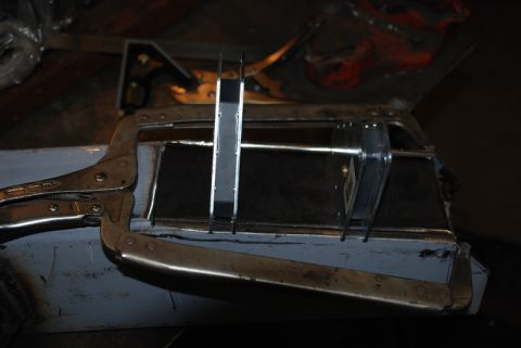 1996 Ford Bronco - Clamps hold metal pieces in place while measurements are taken during auto body repair.