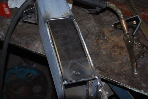 1996 Ford Bronco - A close-up view of a metal frame being welded, with tools present in the background.