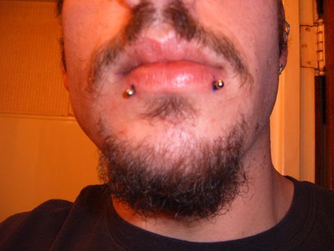 1993 Ford Bronco - A person's face is shown with piercings in their lower lip and a goatee.