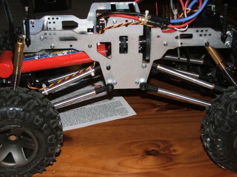 1996 Ford Bronco - Close-up view of the chassis and suspension of a remote control car, showing the battery and wiring.