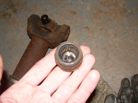 1988 Ford Bronco - A close-up shows a worn universal joint and its bearing cap, likely removed for repair or replacement.
