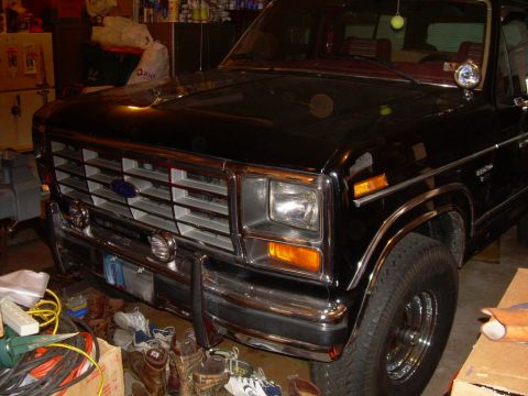 1988 Ford Bronco - Front view of a black Ford Bronco with a chrome grille and bumper.