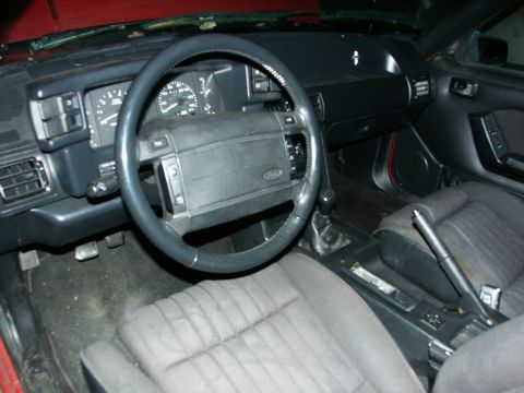 1990 Ford Mustang - Interior view of a 1990 Ford Mustang, the dashboard and driver's seat.