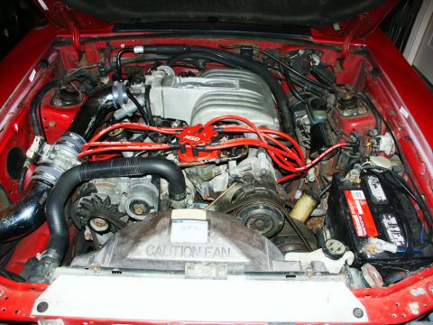 1990 Ford Mustang - The engine bay features an MSD ignition system with red spark plug wires and a red distributor cap.