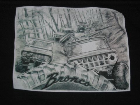 1991 Ford Bronco - This illustration depicts multiple Ford Broncos navigating a wooded trail, with the word 'Bronco' prominently displayed on a tire.