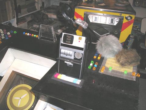 1966 Pontiac Fiero - A collection of items on a console, including miniature vehicles and control panels.