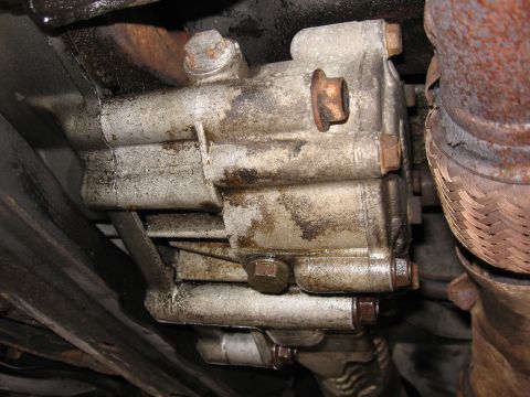 1991 Mitsubishi 3000GT - Underside view of a greasy transmission part, likely from a car or truck.