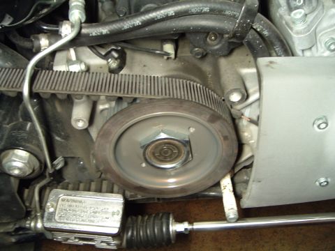 2002 Harley-Davidson Sportster Custom - Close-up view of a motorcycle's engine belt drive mechanism, showing the ribbed belt and pulley.