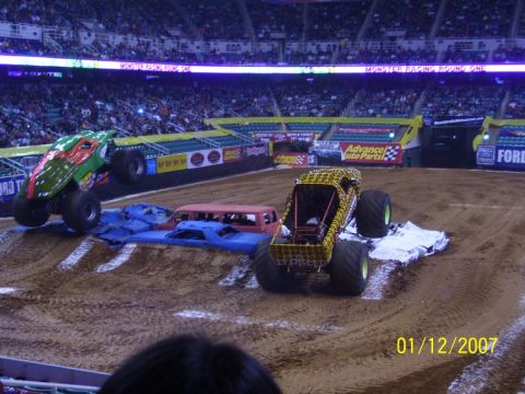 1993 Ford Bronco - Monster trucks compete in an arena, crushing cars as part of the event.
