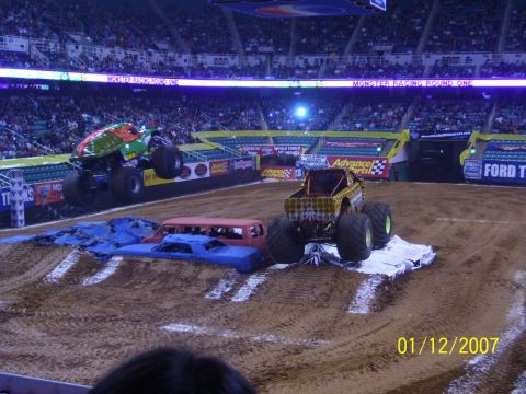 1993 Ford Bronco - Monster trucks compete in an arena, crushing cars as part of the event.