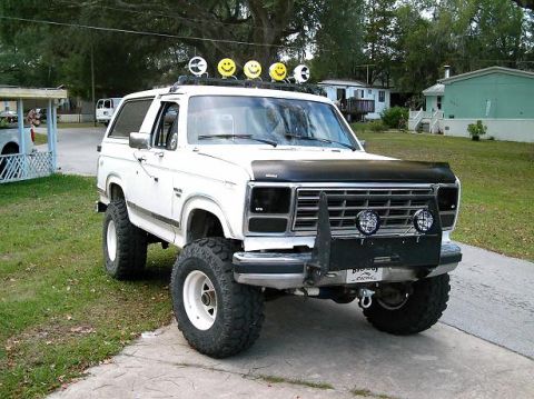 1986 Ford Bronco - This modified Ford Bronco features off-road tires and a custom front bumper with auxiliary lights.