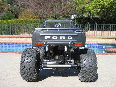 1985 Ford Bronco - This remote-controlled truck features "FORD" lettering on its tailgate and oversized off-road tires.