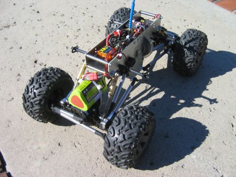 1985 Ford Bronco - This RC truck chassis features a prominent battery pack and visible electronic components, suggesting a custom build.
