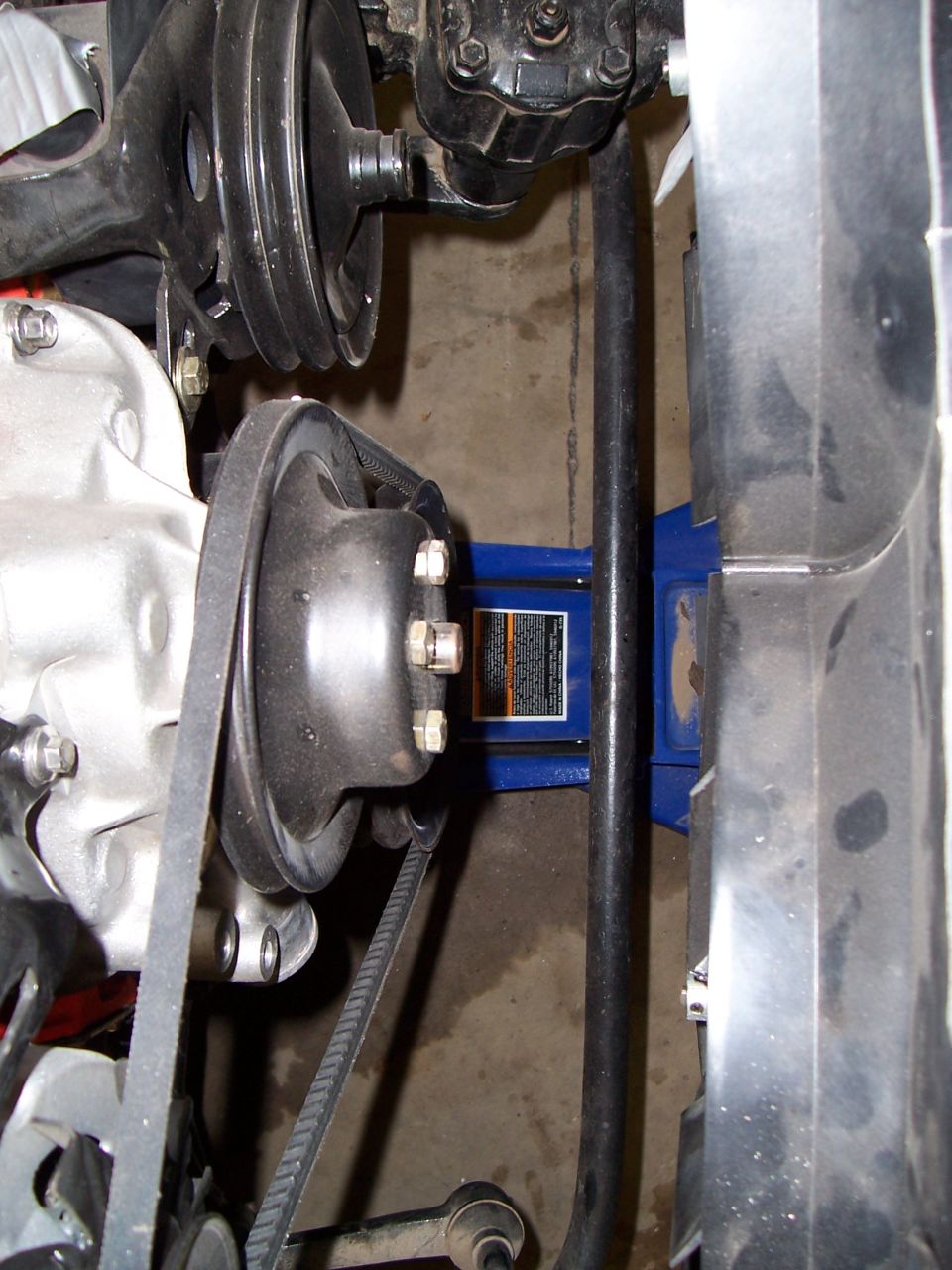 Overhead view of engine front: water pump, harmonic balancer, V-belts and power steering pump