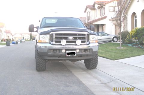 2004 Ford F-250 - This 2004 Ford F-250 truck is shown from the front, its distinctive chrome grille and fog lights.