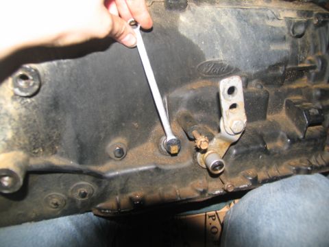 1978 Ford Bronco - Working on a Ford transmission part, using a wrench on a bolt. Ford logo is visible.