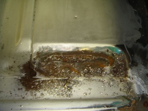 1996 Ford Bronco - This image shows a heavily rusted and damaged floor panel, likely requiring repair.