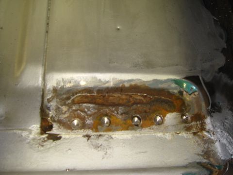 1996 Ford Bronco - This photo shows a section of metal with significant rust damage and evidence of repair work.