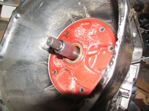 1978 Ford Bronco - A cracked red transmission pump housing is visible with a splined shaft extending from it.