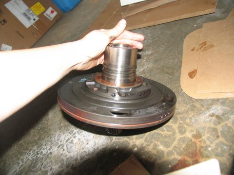 1978 Ford Bronco - Transmission pump part being held by a hand, likely during a repair or rebuild.
