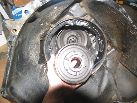 1978 Ford Bronco - A transmission clutch pack is held within the bell housing during a tear-down.