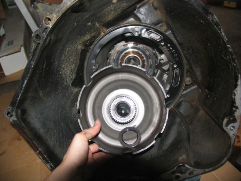 1978 Ford Bronco - Close-up view of a disassembled automatic transmission, focusing on the torque converter and its housing.