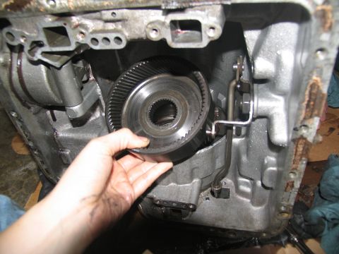 1978 Ford Bronco - Close-up of a transmission component being removed from its housing.