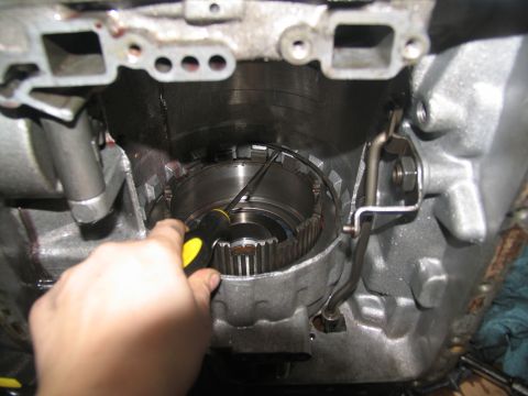 1978 Ford Bronco - Close-up of transmission components being serviced with a screwdriver.