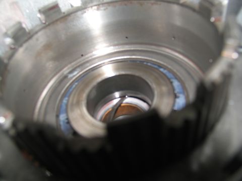 1978 Ford Bronco - This is a close-up view of a disassembled transmission component, showing internal gears and a blue seal.