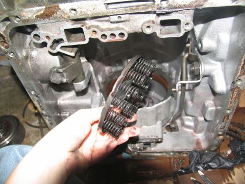 1978 Ford Bronco - A person holds a disassembled transmission valve body, showing numerous small springs.