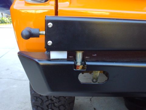 1977 Ford Bronco - Aftermarket rear bumper detail, showing mounting hardware and tire carrier attachment point.