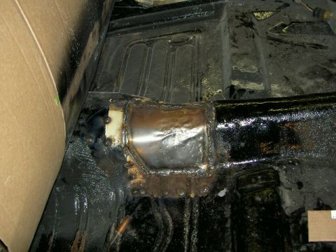 1967 Ford Ranchero - Close-up of a patched floor pan in a 1967 Ford Ranchero, showing welding and structural repairs.