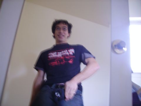 1989 Ford Bronco - A man poses for a photo indoors, wearing a graphic t-shirt and jeans.