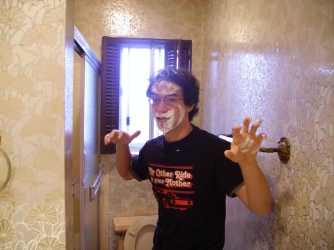 1989 Ford Bronco - A man with shaving cream on his face stands in a bathroom, wearing a novelty t-shirt.
