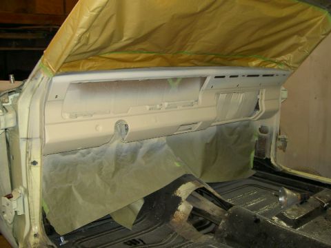 1967 Ford Ranchero - Interior of a vehicle undergoing preparation for painting, with the dashboard and floor area covered.