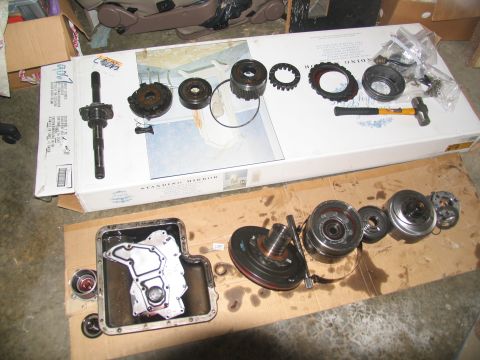 1978 Ford Bronco - Disassembled transmission components are spread out on a work surface, ready for inspection or repair.