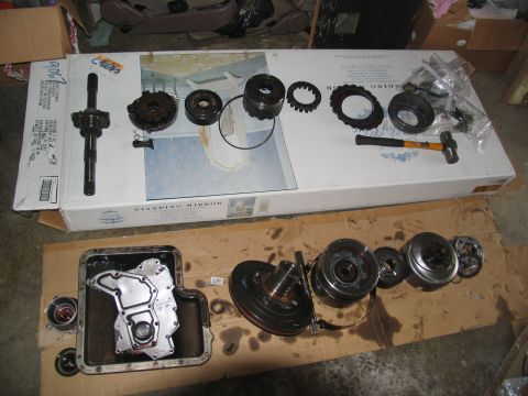 1978 Ford Bronco - Various components of a disassembled automatic transmission are spread out, ready for inspection or repair.