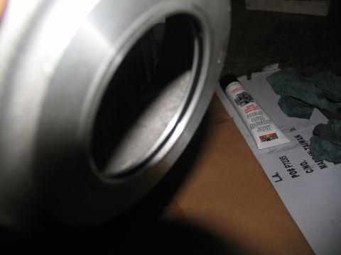 1978 Ford Bronco - A metal component, possibly from a vehicle's transmission, is shown with assembly grease and rags.