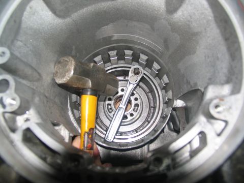 1978 Ford Bronco - A hammer and ratchet are used on a transmission part during a rebuild.